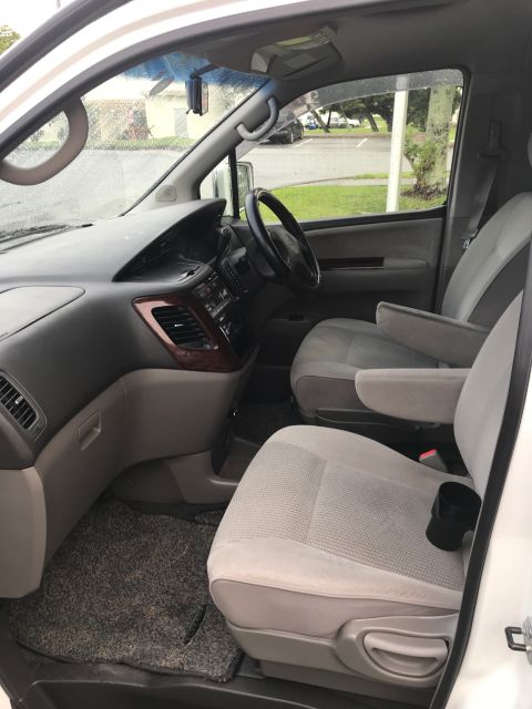 2002 Nissan Quest - Interior view of a minivan showing the front seats, dashboard, and steering wheel.
