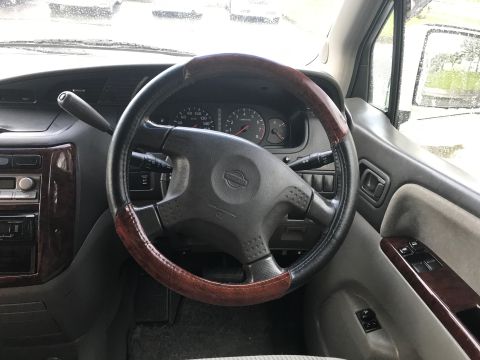 2002 Nissan Quest - The interior of a 2002 Nissan Quest minivan is visible, focusing on the steering wheel and dashboard area.
