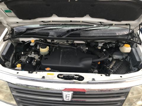 2002 Nissan Quest - The engine bay of a white vehicle is shown, with various components and fluids clearly visible.