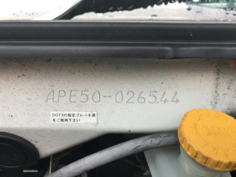2002 Nissan Quest - VIN plate and brake fluid cap on a vehicle.