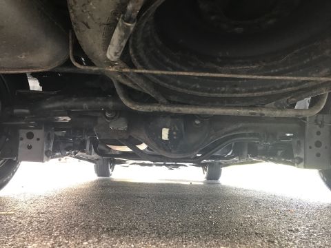 2002 Nissan Quest - The undercarriage of a vehicle is visible, with a focus on the rear axle and suspension components.