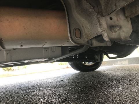 2002 Nissan Quest - Underside view of a vehicle, showing the exhaust system and a rear wheel. The registry claims it is a 2002 Nissan Quest, but this is not ve…