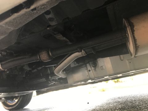 2002 Nissan Quest - The underside of a vehicle, showing the exhaust pipe and muffler system.