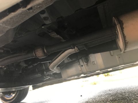 2002 Nissan Quest - The underside of a vehicle is captured, revealing its exhaust system and suspension components.