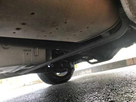 2002 Nissan Quest - A low-angle shot reveals the underside of a vehicle, focusing on the exhaust system and suspension.