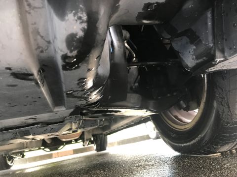 2002 Nissan Quest - Underside view of a vehicle, focusing on mechanical parts and a wheel.