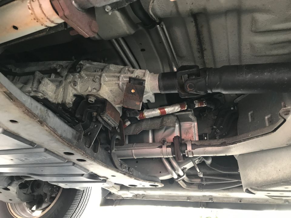 Underside view of vehicle transmission and driveshaft