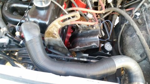 1985 Ford Bronco - A close-up view of the engine bay of a 1985 Ford Bronco, focusing on the engine components, hoses, and belts.