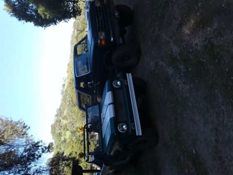 1991 Ford Bronco - A white 1991 Ford Bronco is seen from the side.