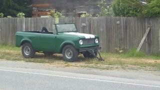 1991 Ford Bronco - This green SUV is parked outdoors next to a fence.