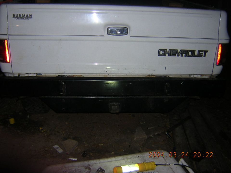 Rear of a white 1984 Chevrolet pickup truck with a black bumper and Chevrolet badging