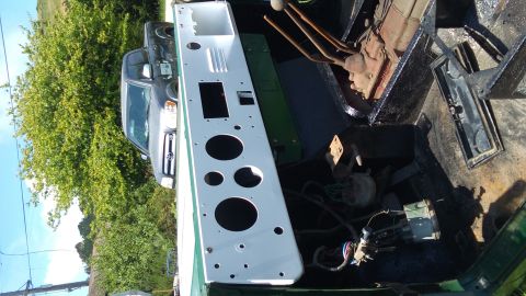 1991 Ford Bronco - The interior of a vehicle is shown, with a white dashboard panel featuring several circular cutouts and a dark green metal box underneath.…