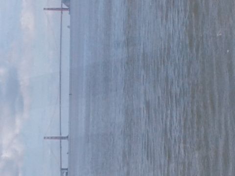 1991 Ford Bronco - The image shows a body of water with a bridge structure in the distance. The bridge appears to be a suspension bridge, possibly the Golden…