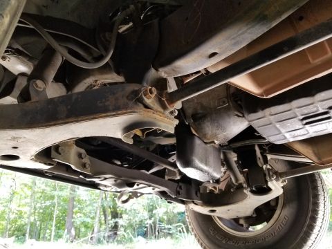 2001 Nissan Xterra - The bellhousing & pan are slightly wet with engine oil, but the rest is fairly clean.