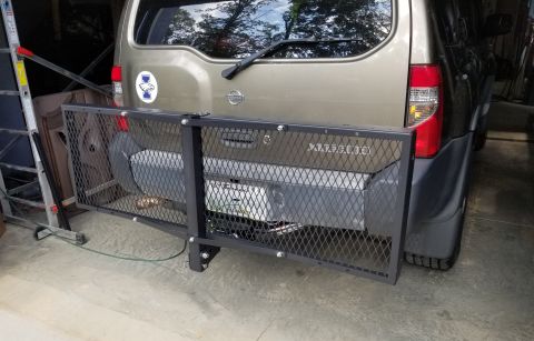 2001 Nissan Xterra - This folding cargo tray came from WalMart. I also put a set of ratchet straps on it & the roof rack. Later, I had to bend the tailpipe slig…