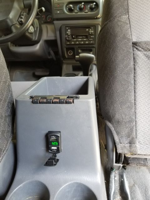 2001 Nissan Xterra - This dual USB power socket is wired to the cigar lighter. There's also an FM modulator with iPhone fire connector up front.