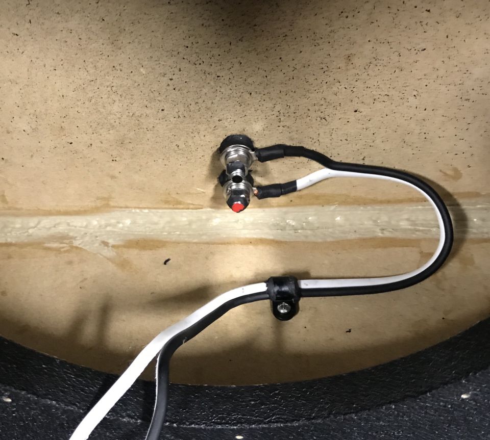 Speaker wire terminals with wires inside a vehicle.