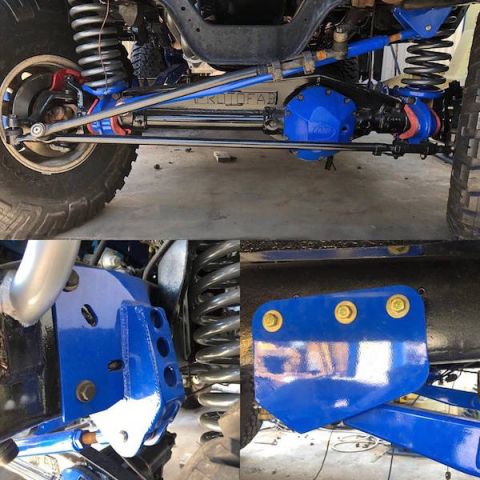 1981 Ford Bronco - The underside of a modified vehicle, likely a 4x4, shows a bright blue differential housing and suspension components. The image captures t…
