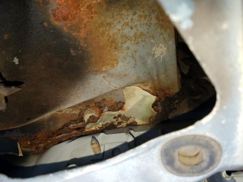 1994 Ford Bronco - Photograph of rusted sheet metal on a vehicle, not a technical document.