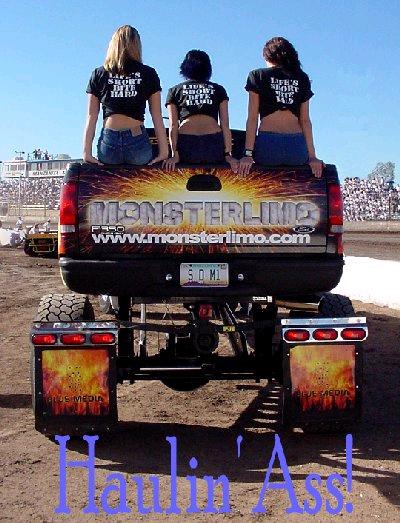 1988 Ford Bronco - A lifted truck with custom graphics and three women sitting on the tailgate at an outdoor event.