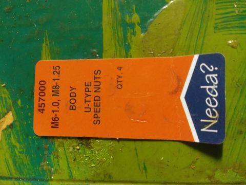 1996 Ford Bronco - An orange label with white and blue text is affixed to a green surface. The label reads "457000 M6-1.0, M8-1.25 BODY U-TYPE SPEED NUTS QTY.…