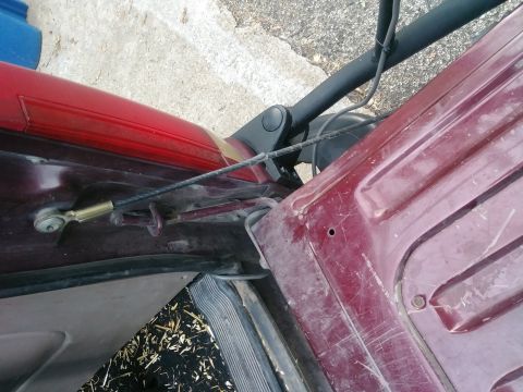 1996 Ford Bronco - Detail of a vehicle's door latch and cable assembly, showing mechanical components.