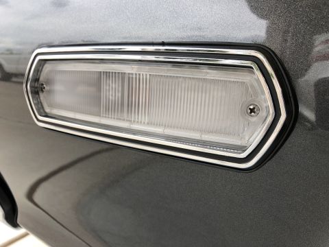 1968 Mercury Cougar - Close-up of a vehicle's taillight assembly, showing its ribbed lens and chrome bezel.