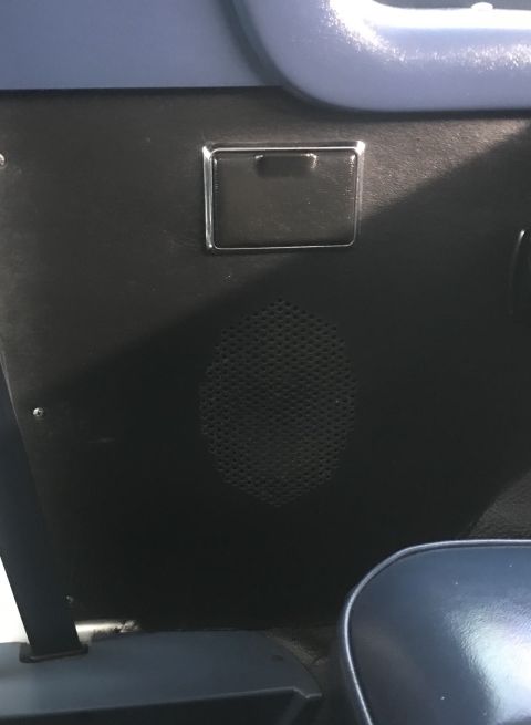 1995 Ford Bronco - Interior view of a car door panel, showing a speaker and an ashtray.