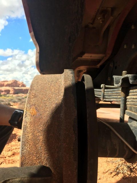 1995 Ford Bronco - This photo shows a close-up of a vehicle's brake rotor and suspension components against a desert backdrop.