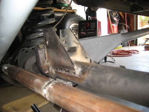 1981 Ford Bronco - A close-up view of the underside of a vehicle, focusing on suspension components and newly welded metal brackets. A Lincoln Pro-Mig 135 wel…