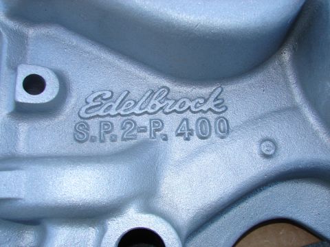 1973 Ford Ranchero - A close-up shot of an aluminum intake manifold with the "Edelbrock S.P. 2-P. 400" casting visible. The manifold has a silver-grey finish.