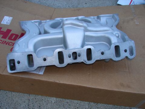 1973 Ford Ranchero - A silver aluminum intake manifold is shown resting on a cardboard box. The manifold has rectangular ports for cylinder head attachment and…