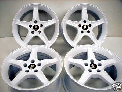 1992 Ford Mustang - Set of four white 1992 Ford Mustang Cobra wheels with black cobra emblems visible.