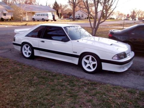 1992 Ford Mustang - A white 1992 Ford Mustang coupe is seen from a three-quarter front angle on a suburban street.