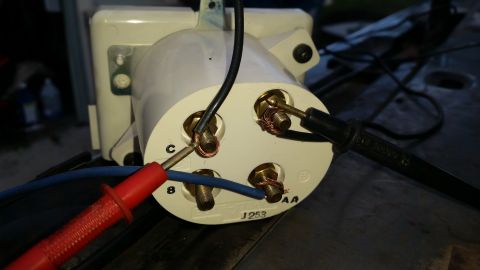1985 Ford Bronco - A close-up view of the back of a white electrical component, possibly a voltage regulator or ignition coil, with several terminals. Test pr…
