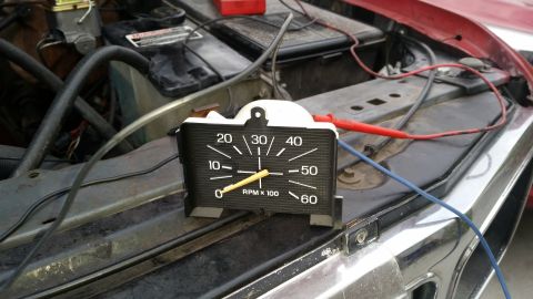1985 Ford Bronco - A tachometer is connected to the engine bay of a vintage Ford Bronco. The tachometer shows a reading of approximately 2500 RPM.