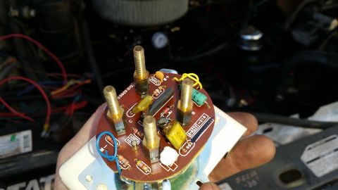 1985 Ford Bronco - A close-up shot shows the internal components of a gauge or instrument cluster, including a circuit board with resistors, capacitors, and s…