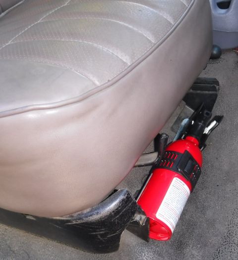 1992 Ford Bronco - First Alert AUTO5 fire extinguisher, mounted to passenger seat front bolts; just enough clearance for seat slider & lever.