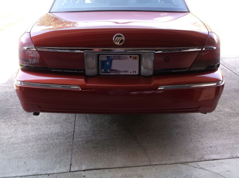 Rear view of a red 1999 Mercury Grand Marquis LS with Indiana license plate.