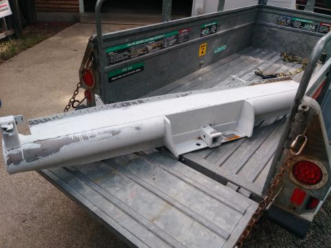 1996 Ford Bronco - A white painted trailer hitch receiver is loaded onto a metal trailer. The trailer has a chain attached to a red taillight on the right sid…