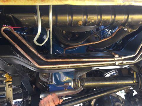 1978 Ford Bronco - Underneath view of a vehicle's engine bay and suspension components. Copper and white lines are visible, along with black painted frame par…