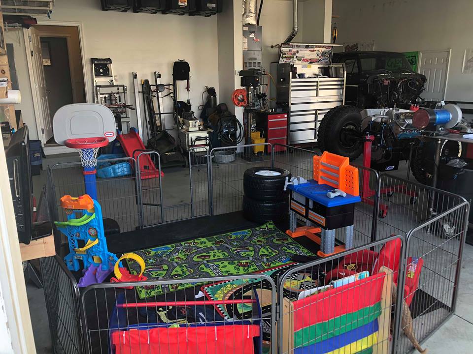 1979 Ford Bronco with engine out, in a garage with a child's play area.