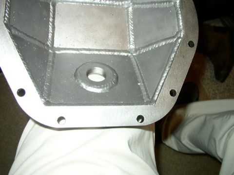 1995 Ford Bronco - Close-up of a differential cover, showing its construction with welded internal bracing and a threaded opening.