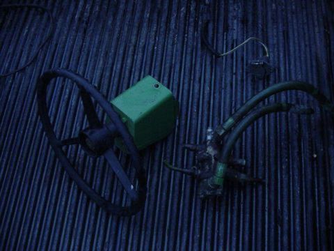 1992 Ford Bronco - Steering wheel and hydraulic pump assembly with hoses, likely for a tractor or industrial equipment.