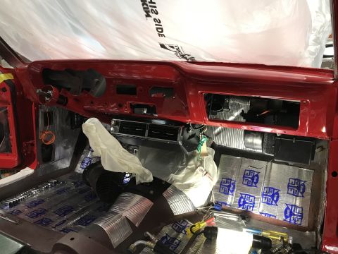 1964 Ford Fairlane - The interior of a classic car, likely a 1964 Ford Fairlane, is shown with the dashboard removed and sound deadening material applied to the…