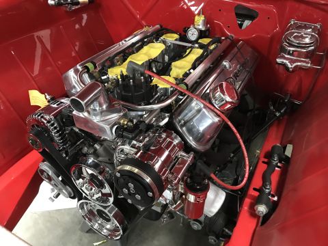 1964 Ford Fairlane - A highly polished, custom V8 engine is installed in a red vehicle. The engine features chrome components, yellow engine covers, and a red s…