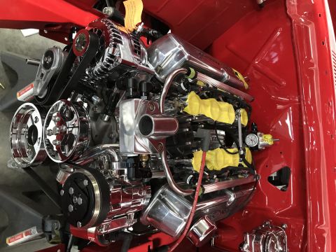 1964 Ford Fairlane - A highly polished chrome supercharged V8 engine is installed in the engine bay of a red vehicle. The engine features a serpentine belt syst…