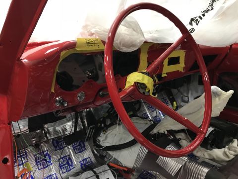 1964 Ford Fairlane - Interior view of a red classic car, likely a 1964 Ford Fairlane, during restoration. The dashboard and steering wheel are visible, along wi…