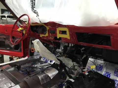 1964 Ford Fairlane - The interior of a classic car undergoing restoration, showing the dashboard, steering wheel, and sound-dampening material on the floor. The…