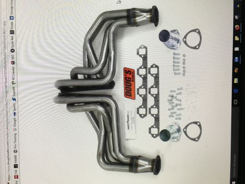 1964 Ford Fairlane - A set of Doug's Headers exhaust headers and gaskets are laid out on a white surface. The headers are made of polished metal and are designe…